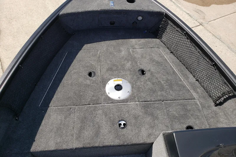 Slide: The Image of 2026 Alumacraft Classic 165 SC boat interior with gray carpet and storage compartments. - 17