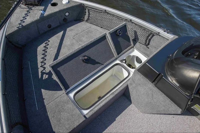 Slide: The Image of 2026 Alumacraft Classic 165 SC boat interior with storage compartments and carpeted deck. - 19