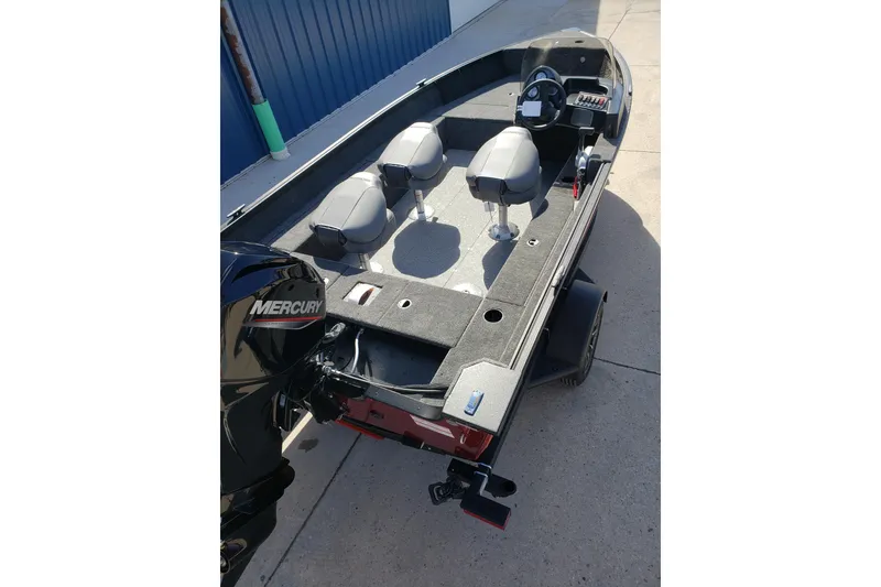 Slide: The Image of 2026 Alumacraft Classic 165 SC boat with Mercury engine, featuring three seats and steering console. - 8