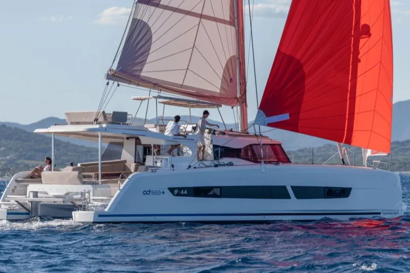 The Image of 2026 Fountaine Pajot 44 catamaran sailing with red sails on open water. - 0