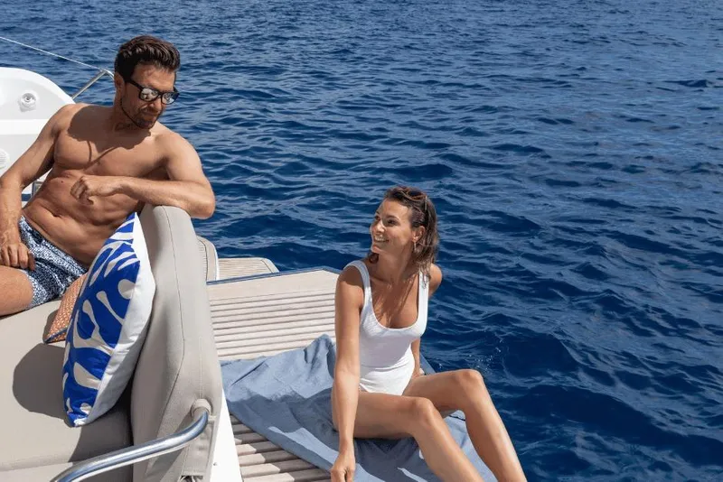 Slide: The Image of Couple relaxing on a 2026 Fountaine Pajot 44 yacht, enjoying the ocean view. - 13
