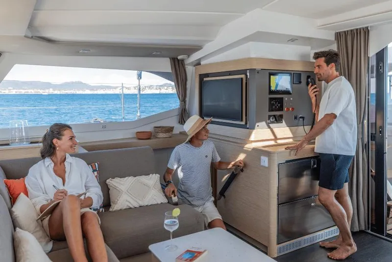 Slide: The Image of People relaxing inside a 2026 Fountaine Pajot 44 yacht, enjoying the ocean view. - 20