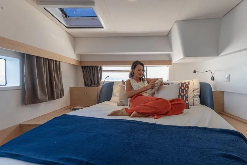 Slide: The Image of Woman relaxing in a luxurious cabin of a 2026 Fountaine Pajot 44 yacht. - 28