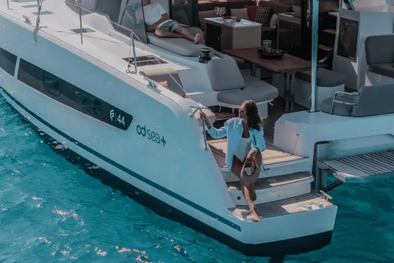 Slide: The Image of Woman boarding 2026 Fountaine Pajot 44 yacht on clear blue water. - 34