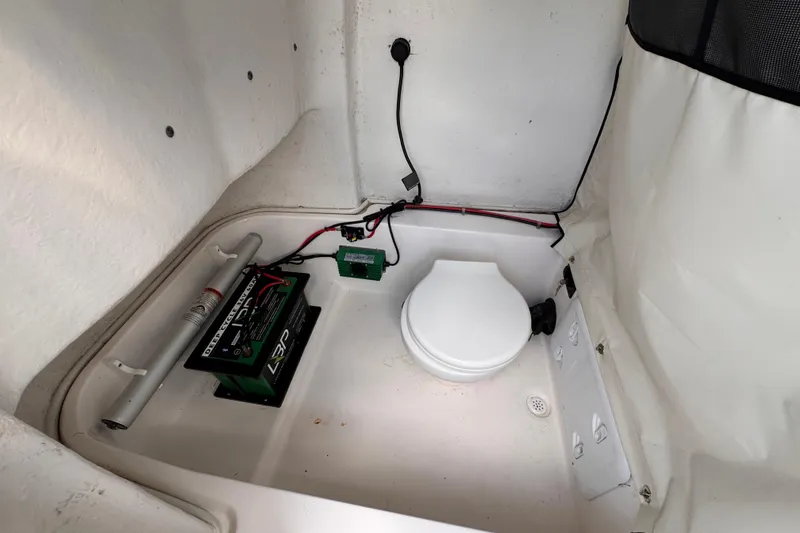 Slide: The Image of 2024 Sea Fox 248 Commander boat interior with battery and toilet setup. - 17