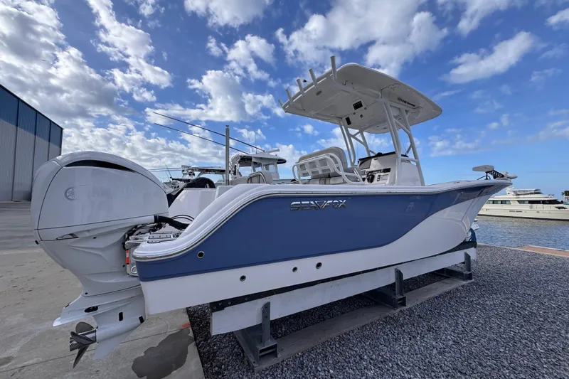 Slide: The Image of 2024 Sea Fox 248 Commander boat docked under a partly cloudy sky. - 3