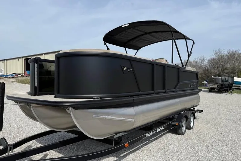 Slide: The Image of 2026 Alera 22q pontoon boat on trailer, featuring sleek black design and canopy. - 1