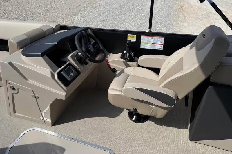 Slide: The Image of Interior of 2026 Alera 22q boat with beige captain's chair and control panel. - 12