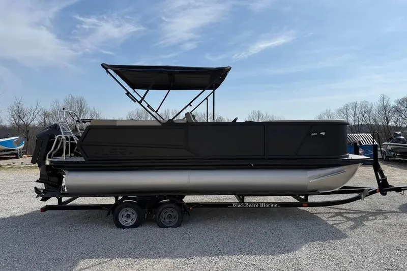 Slide: The Image of Alera 22q 2026 pontoon boat on trailer under clear sky. - 4