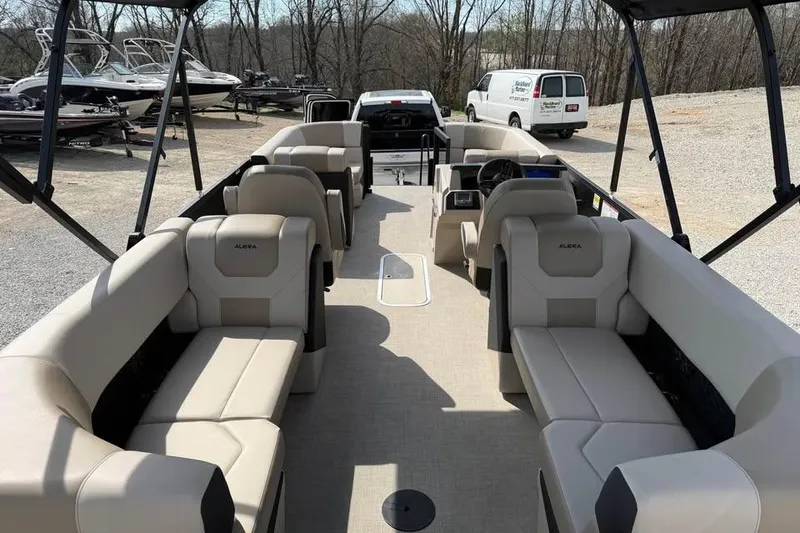 Slide: The Image of Interior view of 2026 Alera 22q pontoon boat with beige seating and steering console. - 9
