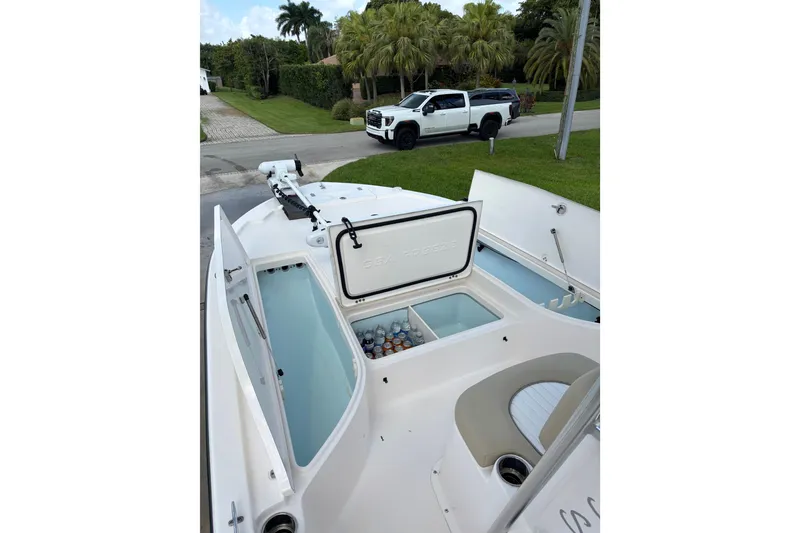 Slide: The Image of 2020 Sea Born FX22 Bay boat with open storage compartments and cooler. - 10
