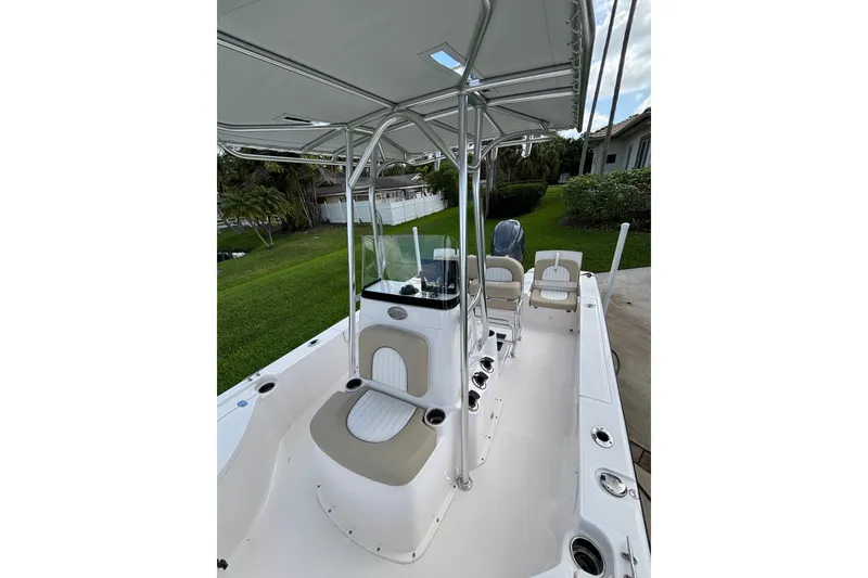 Slide: The Image of 2020 Sea Born FX22 Bay boat interior with seating and console, parked on a lawn. - 13