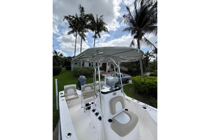 Slide: The Image of 2020 Sea Born FX22 Bay boat with canopy, parked near palm trees. - 17