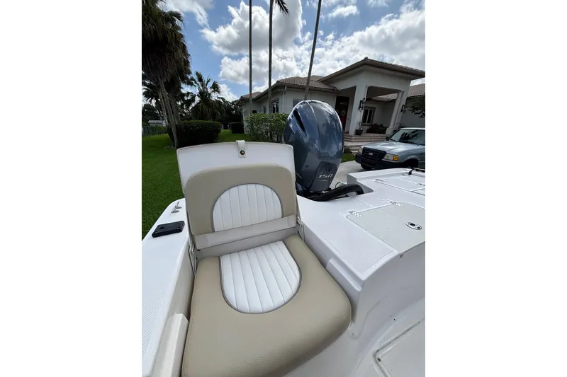 Slide: The Image of 2020 Sea Born FX22 Bay boat with cushioned seating and powerful outboard motor. - 21