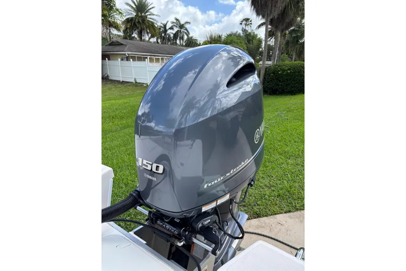 Slide: The Image of Yamaha 150 outboard motor on a 2020 Sea Born FX22 Bay boat, parked on grass. - 22
