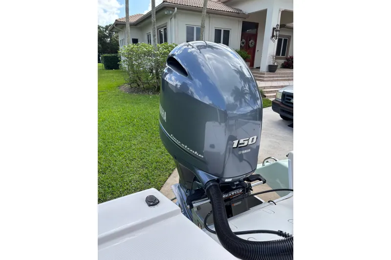 Slide: The Image of 2020 Sea Born FX22 Bay boat with Yamaha 150 outboard motor in residential driveway. - 23