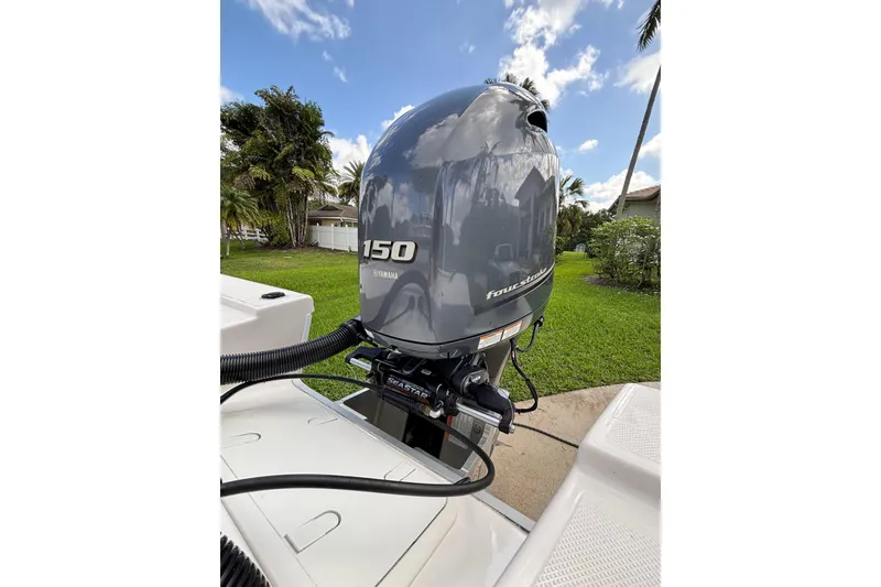 Slide: The Image of 2020 Sea Born FX22 Bay boat with Yamaha 150 outboard motor in a grassy yard. - 25