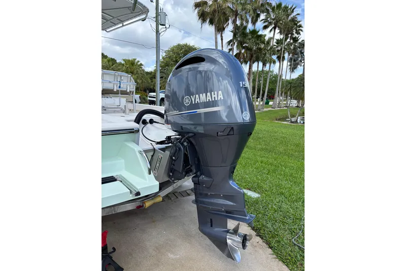 Slide: The Image of 2020 Sea Born FX22 Bay boat with Yamaha 150 outboard motor, parked near palm trees. - 31