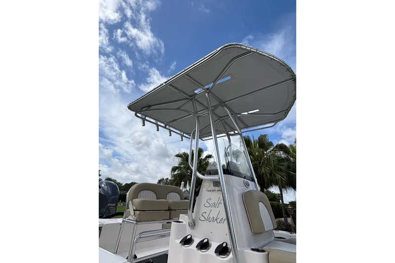 Slide: The Image of 2020 Sea Born FX22 Bay boat with T-top under a blue sky. - 6