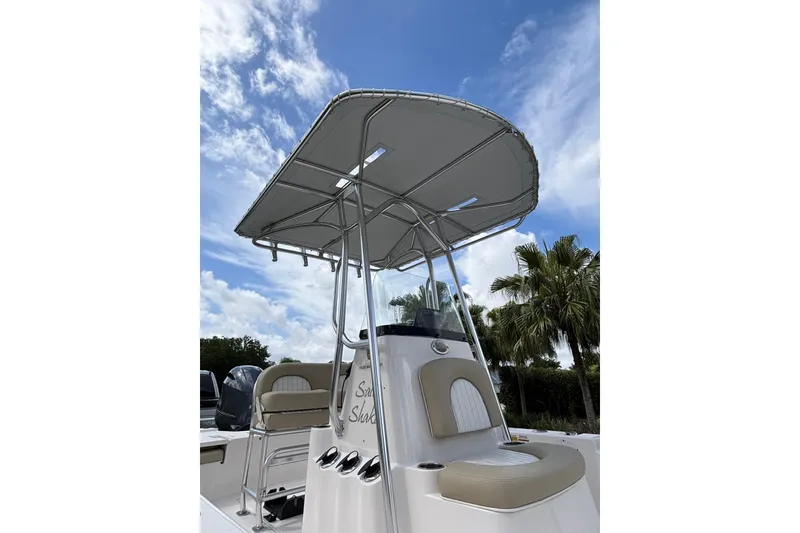 Slide: The Image of 2020 Sea Born FX22 Bay boat with T-top under a blue sky. - 7