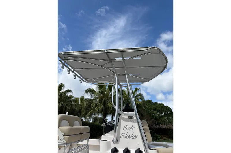 Slide: The Image of 2020 Sea Born FX22 Bay boat with T-top against a blue sky background. - 8