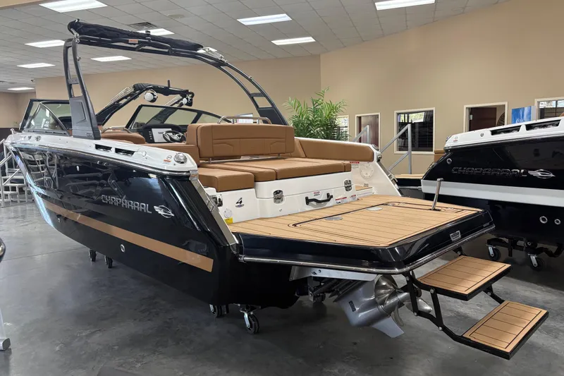 The Image of 2026 Chaparral SSX 4 boat with sleek design, showcased indoors, featuring luxurious seating and swim platform. - 0