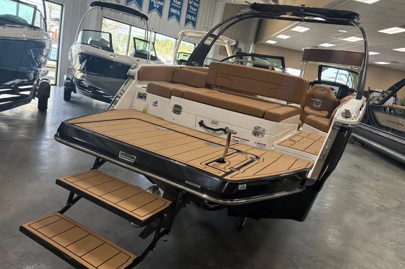 Slide: The Image of 2026 Chaparral SSX 4 boat with tan seating and swim platform in showroom. - 2