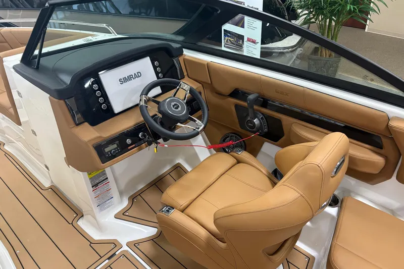 Slide: The Image of 2026 Chaparral SSX 4 boat interior with tan leather seats and Simrad navigation system. - 5