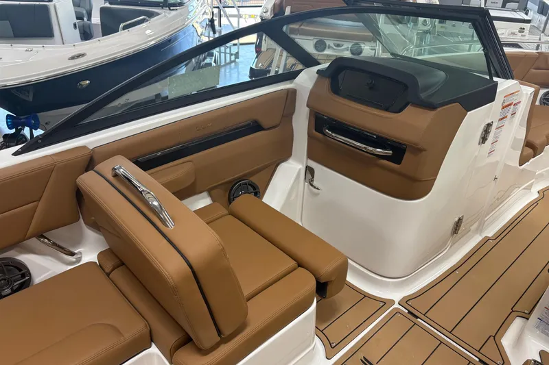 Slide: The Image of 2026 Chaparral SSX 4 boat interior with tan leather seating and sleek design. - 7