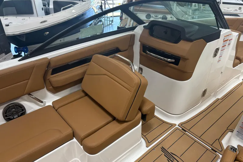 Slide: The Image of 2026 Chaparral SSX 4 boat interior with tan leather seating and modern dashboard. - 8
