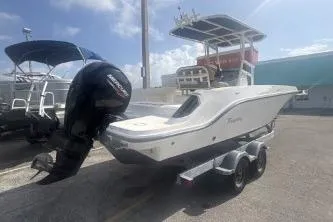 Slide: The Image of 2023 Bayliner Trophy T22CC boat with outboard motor on trailer, parked outdoors. - 4