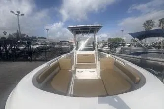 Slide: The Image of 2023 Bayliner Trophy T22CC boat with spacious seating and sleek design under a cloudy sky. - 5