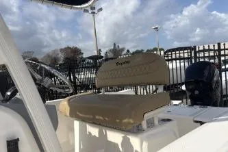 Slide: The Image of 2023 Bayliner Trophy T22CC boat interior with beige seating and steering wheel. - 7