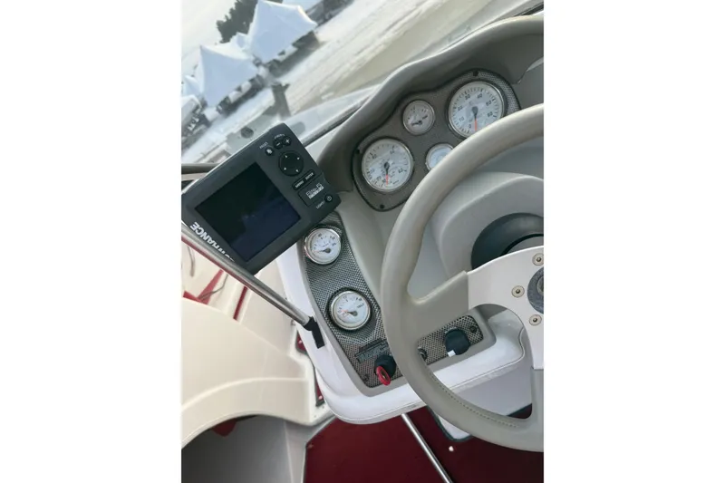 Slide: The Image of 1998 Larson Escape Delta-Conic dashboard with gauges and navigation system. - 12