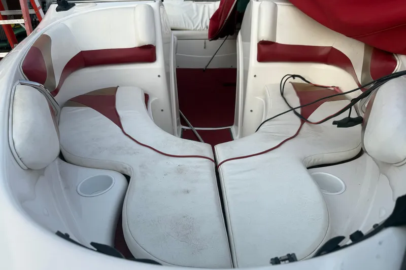 Slide: The Image of Interior of a 1998 Larson Escape Delta-Conic boat with white and red seating. - 14