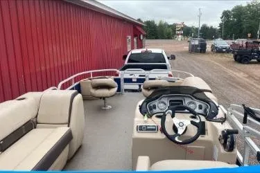 Slide: The Image of 2015 Sun Tracker Fishin' Barge 22 DLX pontoon boat with seating and steering console. - 3