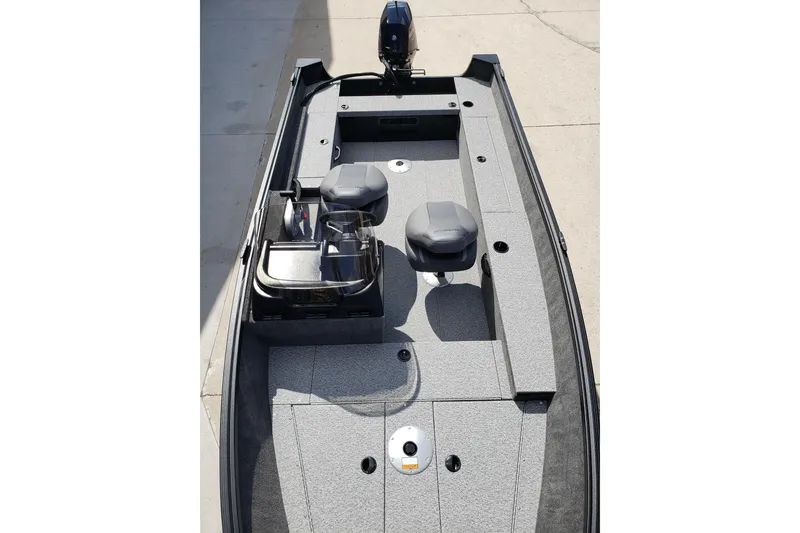 Slide: The Image of 2026 Alumacraft Escape 165 CS boat interior with seating and motor, viewed from above. - 10