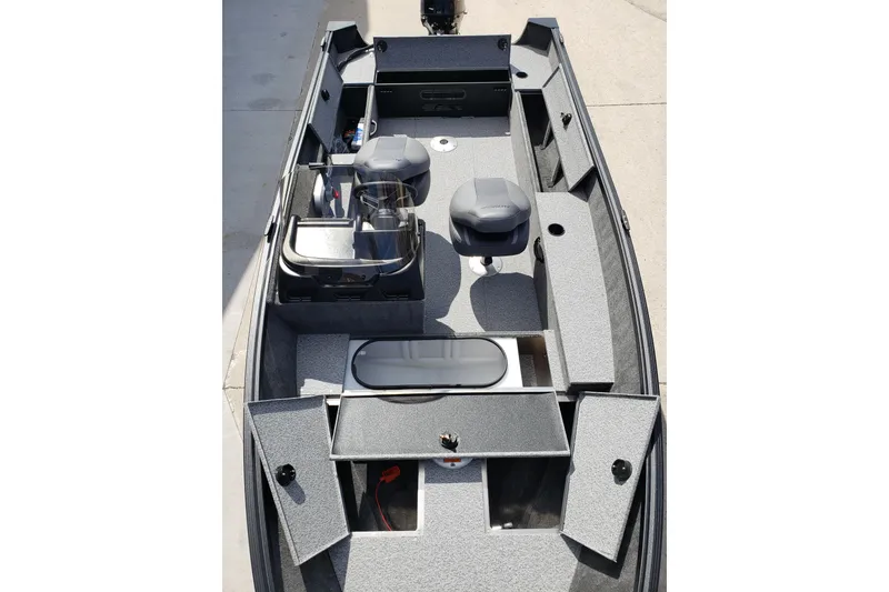 Slide: The Image of 2026 Alumacraft Escape 165 CS boat interior with seating and storage compartments. - 11