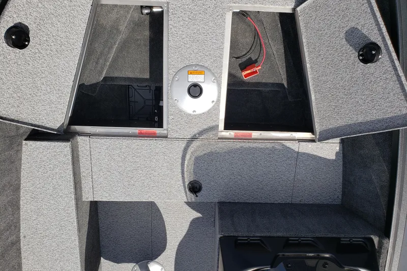 Slide: The Image of 2026 Alumacraft Escape 165 CS boat interior with open storage compartments. - 13