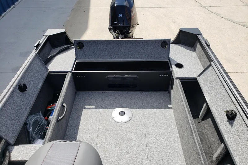 Slide: The Image of 2026 Alumacraft Escape 165 CS boat interior with storage compartments and motor. - 14