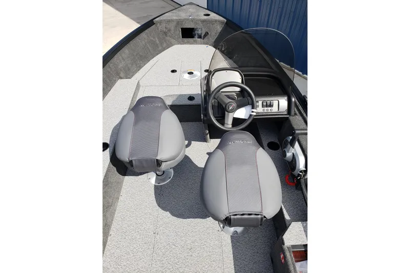 Slide: The Image of 2026 Alumacraft Escape 165 CS boat interior with steering wheel and two seats. - 15