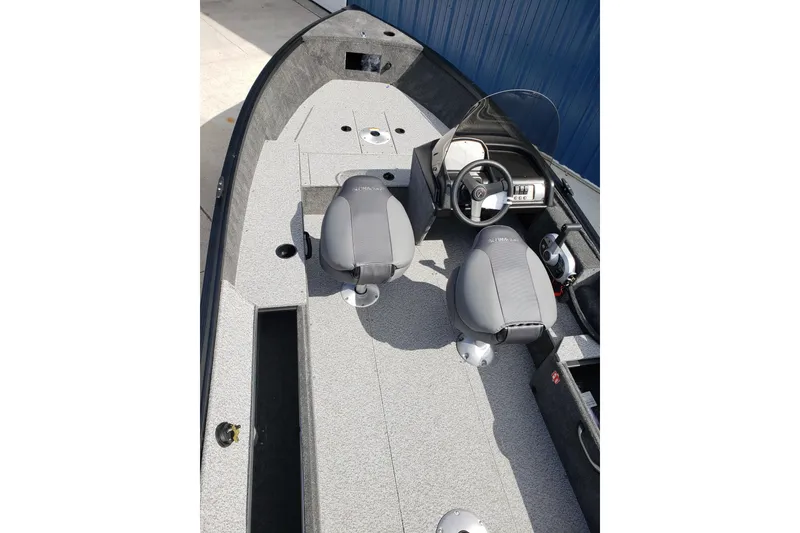 Slide: The Image of 2026 Alumacraft Escape 165 CS boat interior with dual seats and steering console. - 17