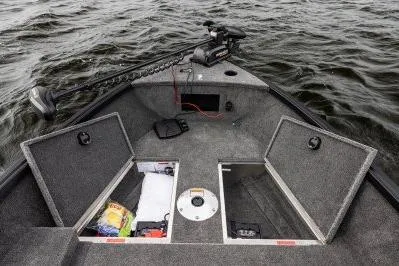 Slide: The Image of 2026 Alumacraft Escape 165 CS boat interior with storage compartments open on a lake. - 18