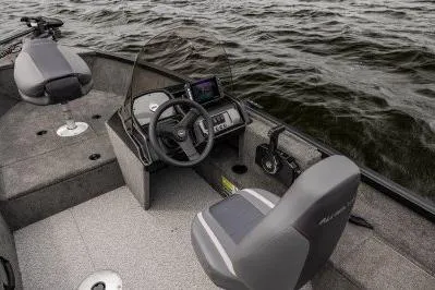 Slide: The Image of 2026 Alumacraft Escape 165 CS boat interior with steering console on open water. - 3