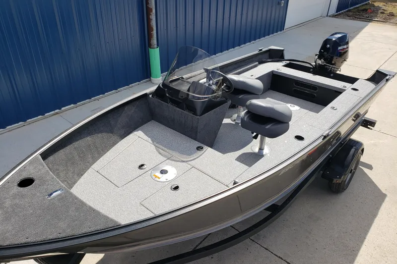 Slide: The Image of 2026 Alumacraft Escape 165 CS fishing boat with dual seats and outboard motor. - 9