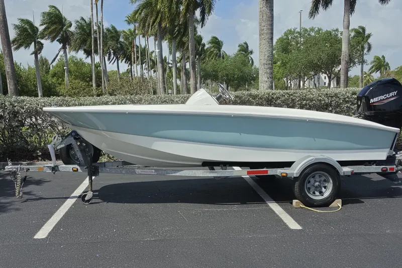 The Image of 2012 Boston Whaler 15 Super Sport boat on trailer, parked near palm trees. - 0