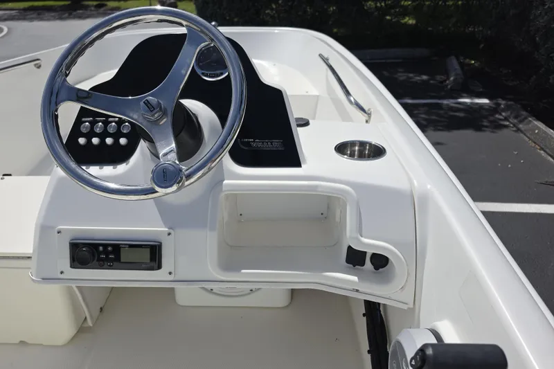 Slide: The Image of 2012 Boston Whaler 15 Super Sport boat dashboard with steering wheel and controls. - 11