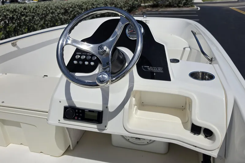 Slide: The Image of 2012 Boston Whaler 15 Super Sport boat dashboard with steering wheel and controls. - 12