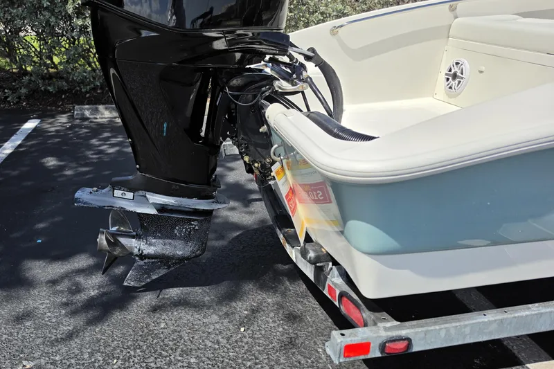 Slide: The Image of 2012 Boston Whaler 15 Super Sport boat on trailer, showing motor and hull details. - 14