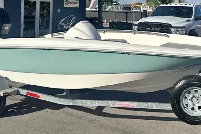 Slide: The Image of 2012 Boston Whaler 15 Super Sport boat on trailer, parked outdoors. - 15